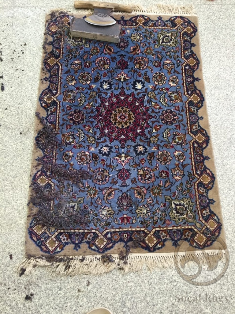 Hand scraper shearing tool on blue rug