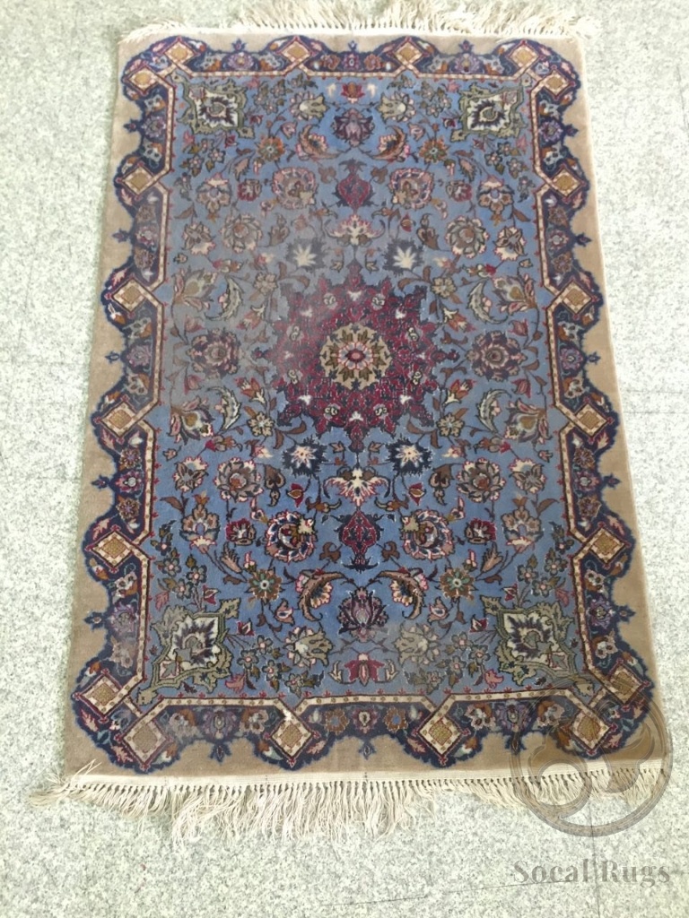 Dull and faded blue Kashan rug before shearing