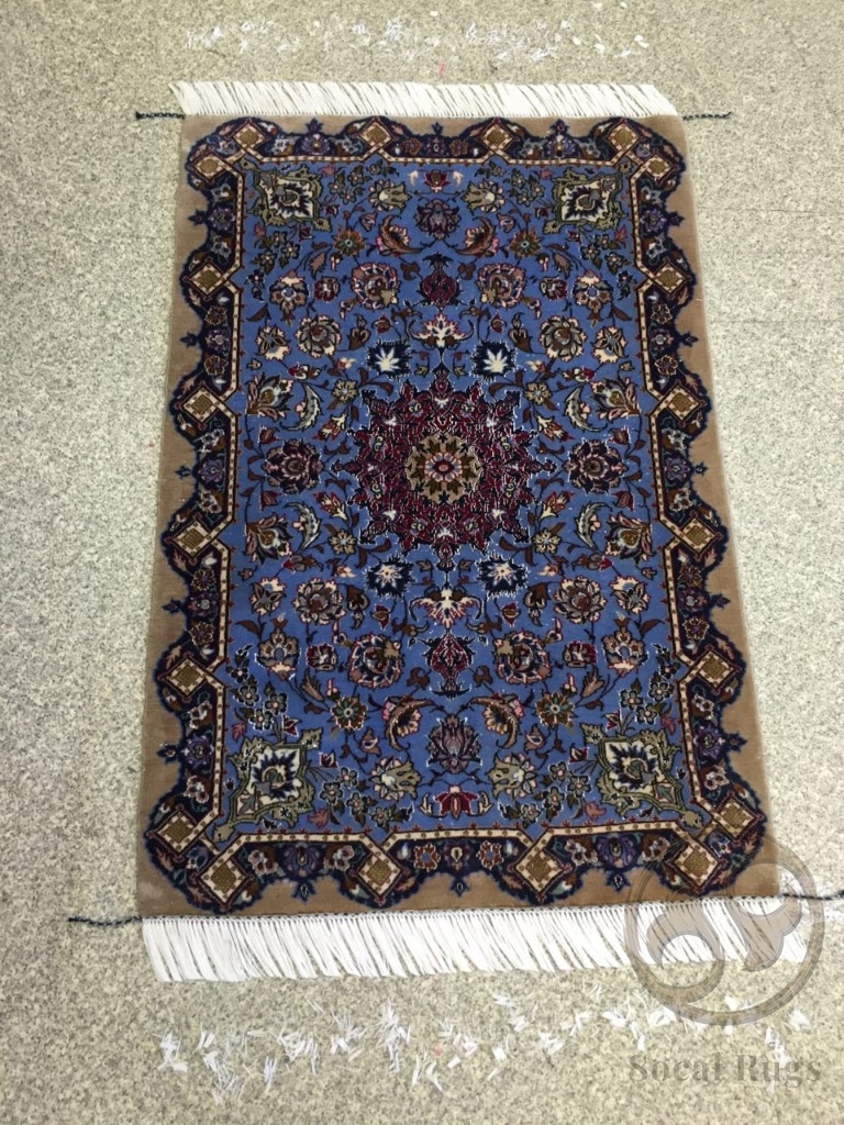 Clean, bright blue Kashan rug completed